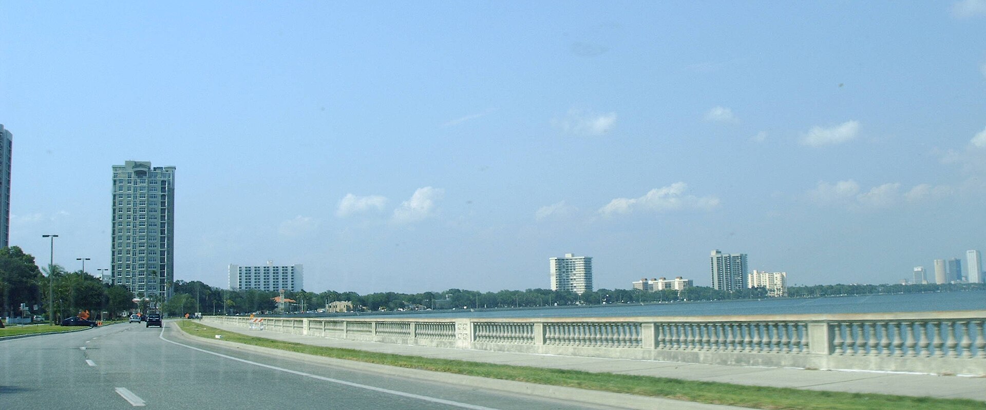 The balustraded seawall along Bayshore Boulevard beside Hillsborough Bay, with residential towers in the distance