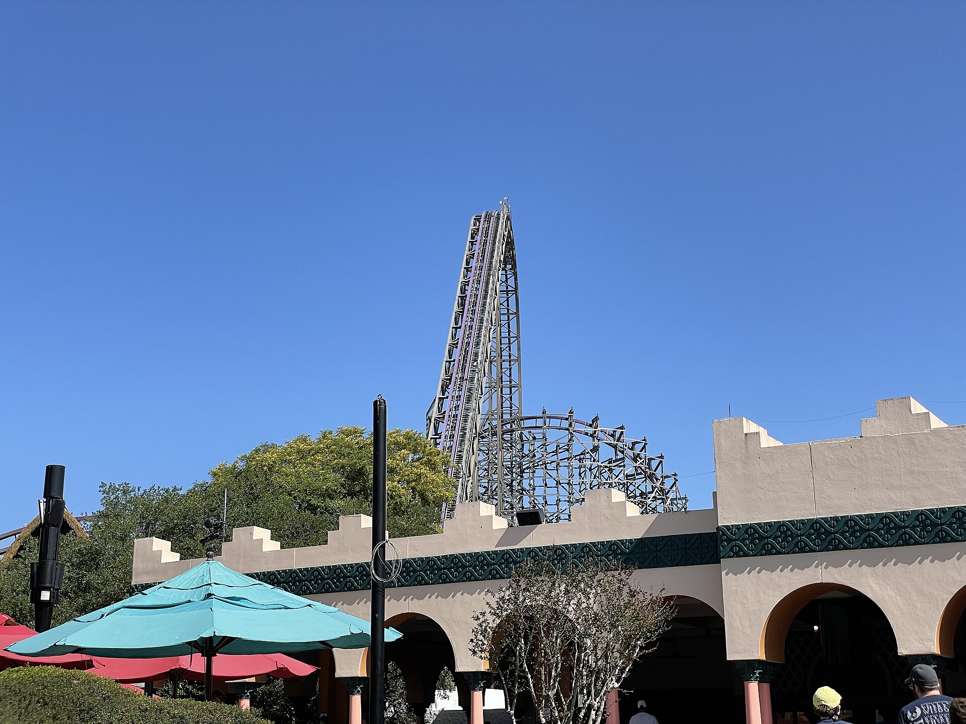 The steep lift hill of the Iron Gwazi roller coaster rising above Moroccan-style buildings at Busch Gardens Tampa Bay