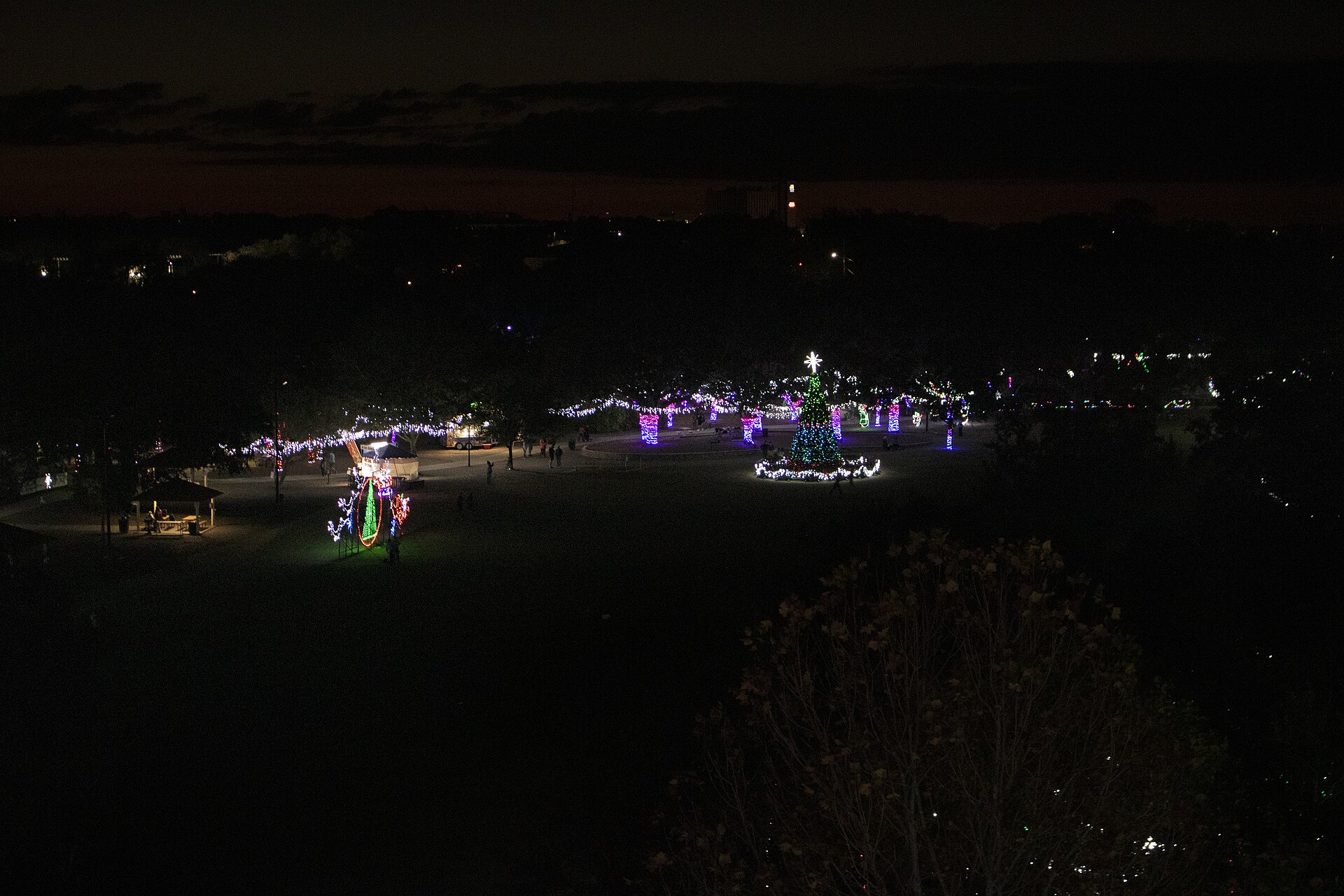 A park at night strung with holiday lights and a lit Christmas tree, seen from above at Largo Central Park in Pinellas County